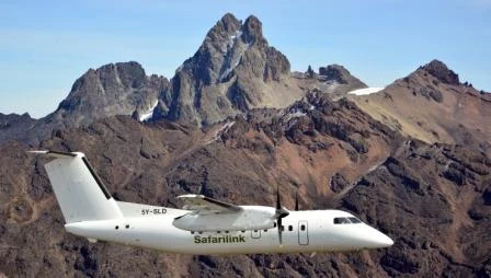 Safarilink flights to the Maasai Mara 3 Safarilink Dash 8 against a mountainous landscape