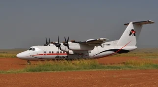 AirKenya Dash 7 parked beside a bush runway