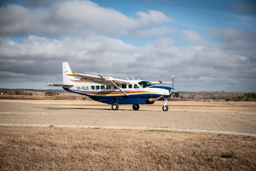 Yellow Wings flights to the Maasai Mara 4 Yellow Wings Caravan parked beside a bush runway