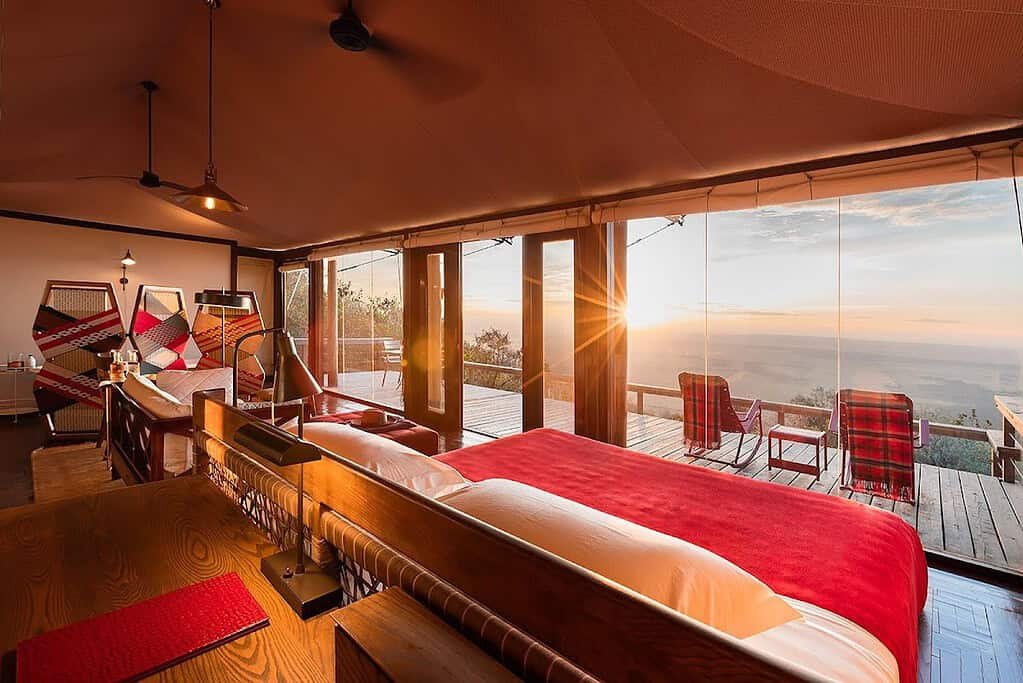 Ultra-luxury camps in the Maasai Mara: a canvas suite with glass doors and a sunset view