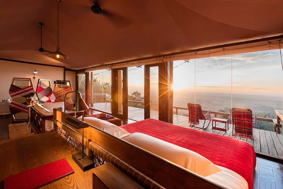 Ultra-luxury camps and lodges in the Maasai Mara 1 Ultra-luxury camps in the Maasai Mara: a canvas suite with glass doors and a sunset view