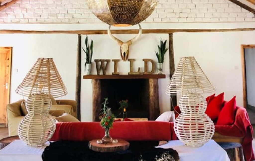 Wild Bandas shared lounge with fireplace and red seating