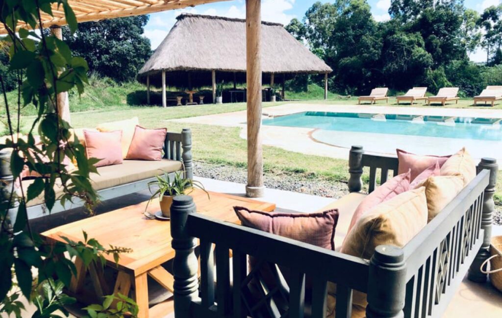 Wild Bandas shared swimming pool with shaded veranda and thatched gazebo