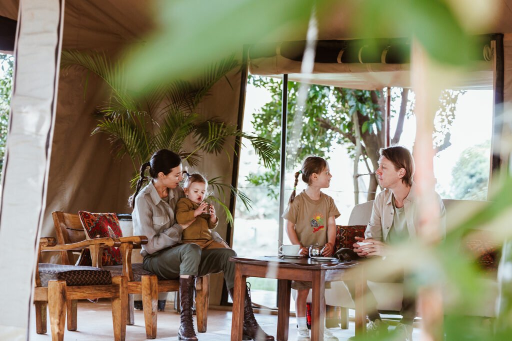 Basecamp Adventure guests seated around a table in a shared dining and seating area