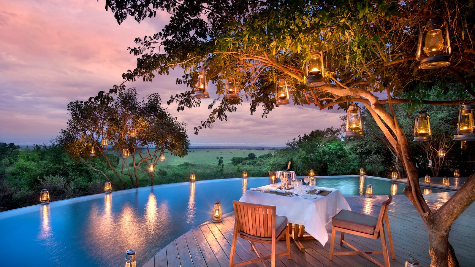 Lantern-lit dining beside the North Camp swimming pool at andBeyond Bateleur