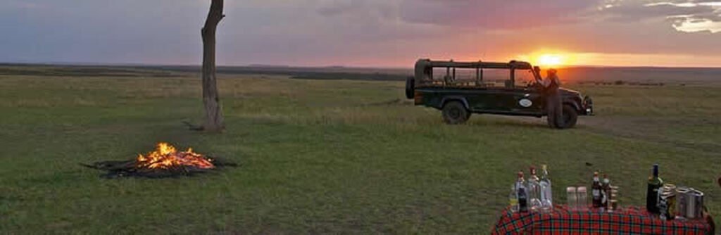 Bush dining at sunset — safari context, not an Enkolong room or included activity