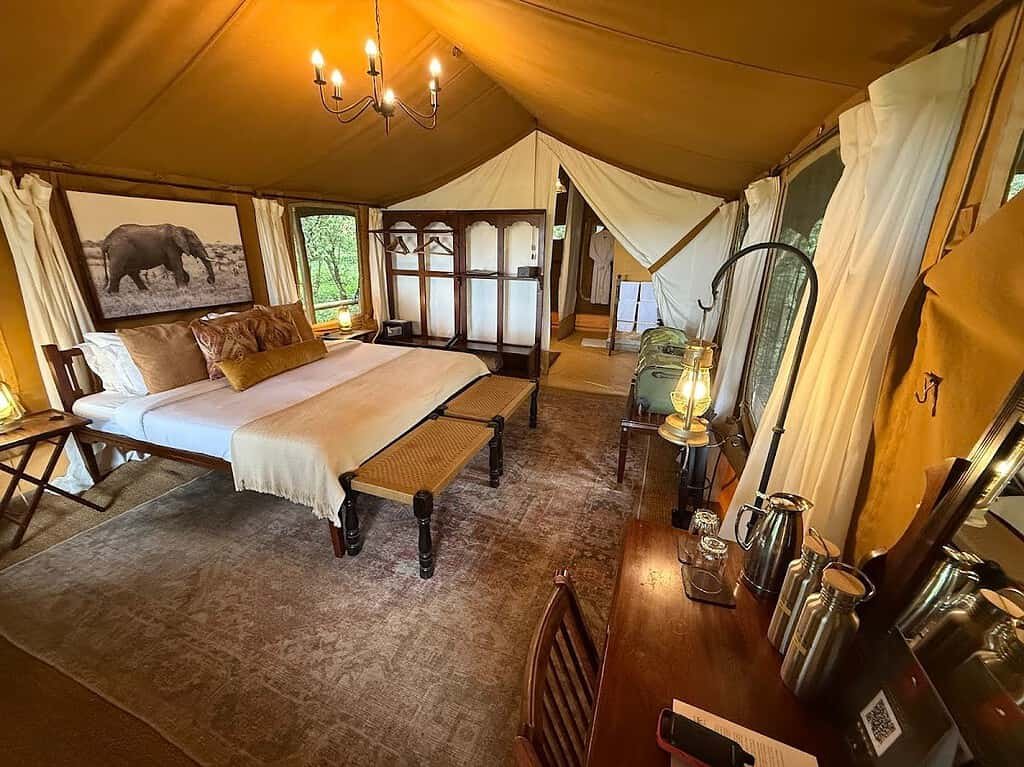 Canvas bedroom with a double bed, writing desk and an open seating area
