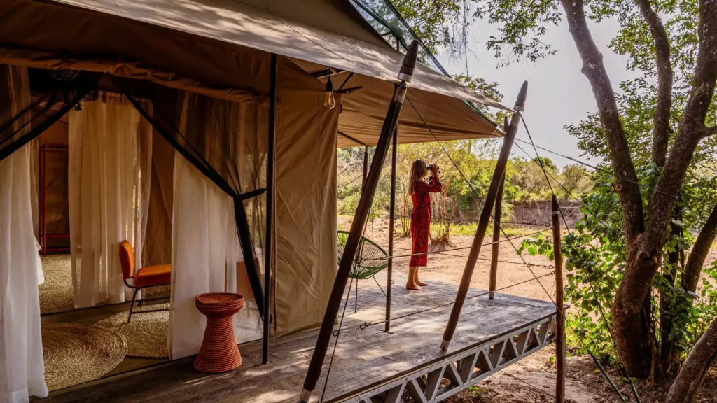 Emboo Camp canvas guest tent and private veranda among riverside trees