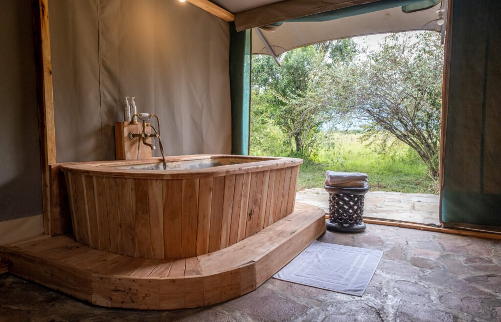 Wooden soaking bath beside the open bush view in Enkakenya’s Director’s Tent