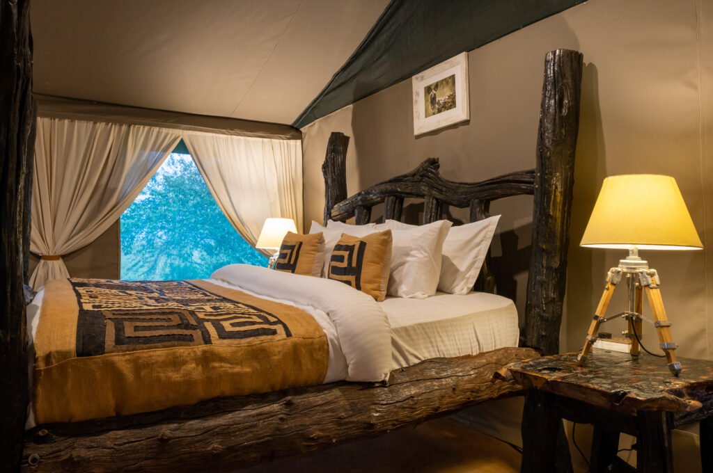 Maasai Mara lodges and camps 12 Enkakenya Mara Camp Director’s Tent with rustic four-poster bed