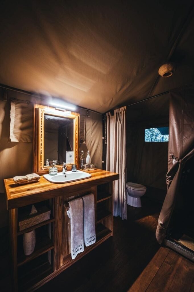 Enkewa Camp private tent bathroom with basin, mirror, WC and branded towels