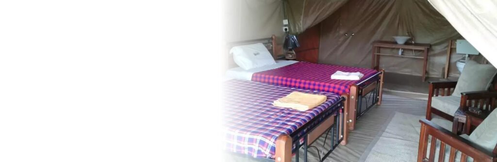 Maasai Mara lodges and camps 21 Enkolong Tented Camp furnished twin tent with timber beds and a washbasin