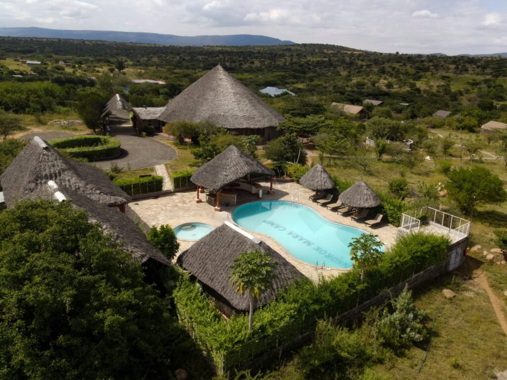 Maasai Mara lodges and camps 13 Enkorok Mara Camp shared swimming pool and thatched public buildings