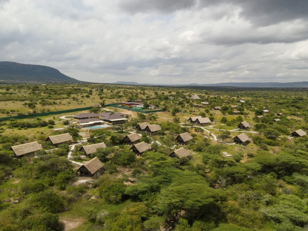 Aerial view of Enkorok Safari Camp tents and rectangular pool beside the main building