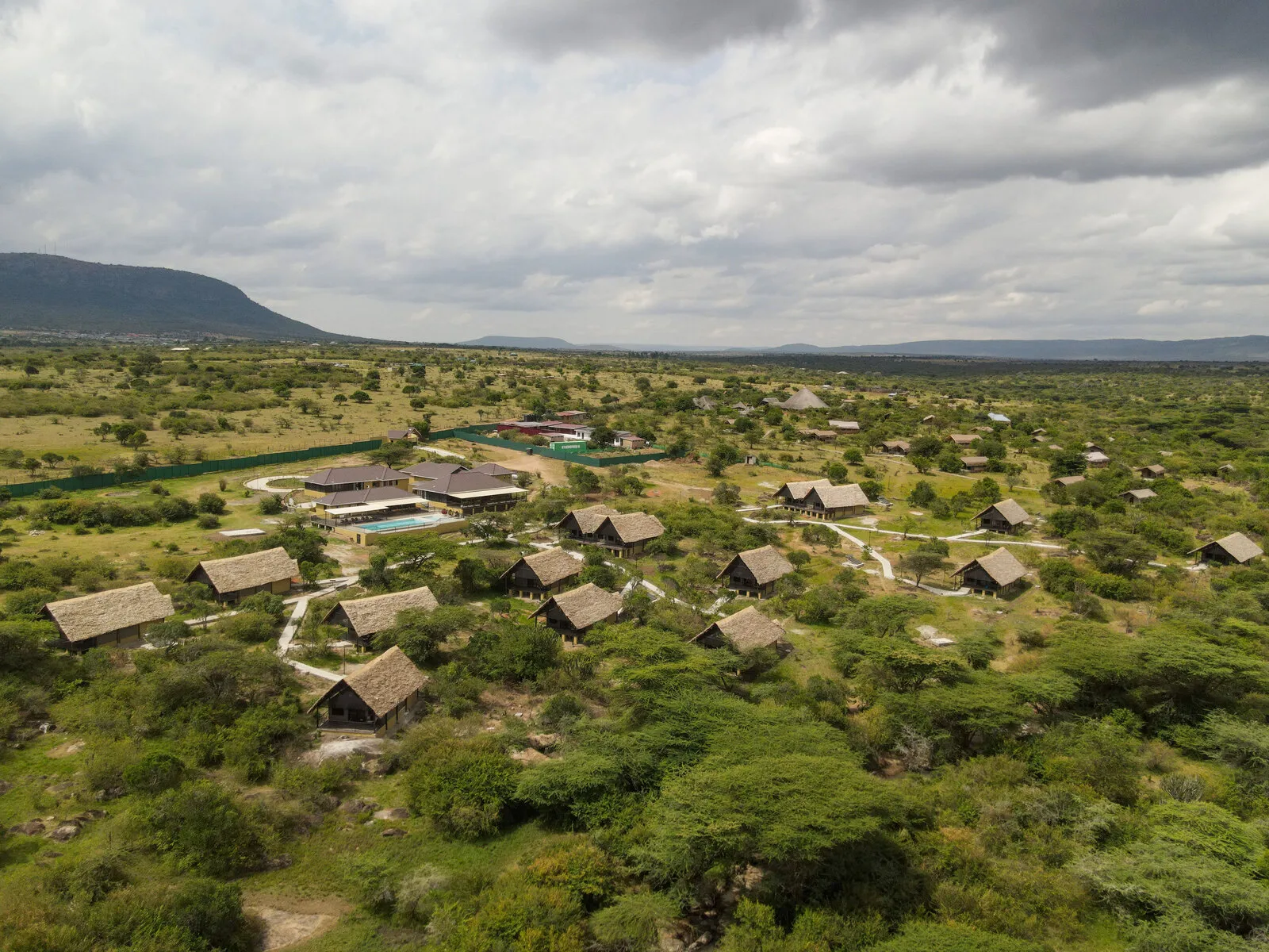 Aerial view of Enkorok Safari Camp tents and rectangular pool beside the main building