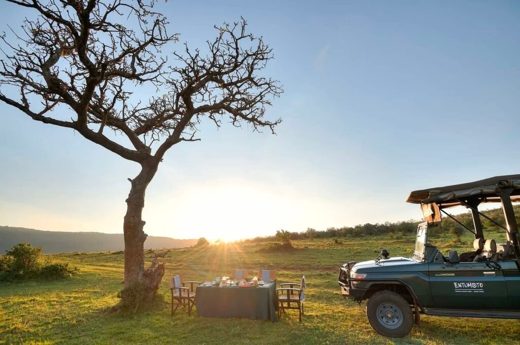 Entumoto outdoor bush-meal table beside its safari vehicle, an arranged activity rather than a full-board room feature
