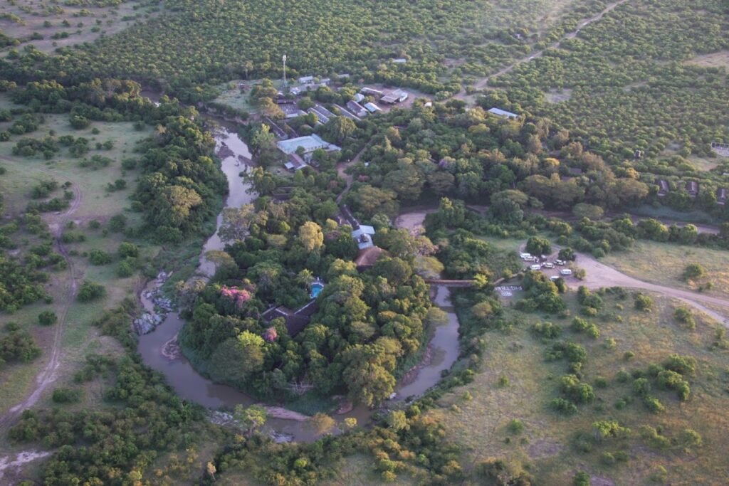 Fig Tree Camp buildings and tree-lined grounds beside a bend in the Talek River