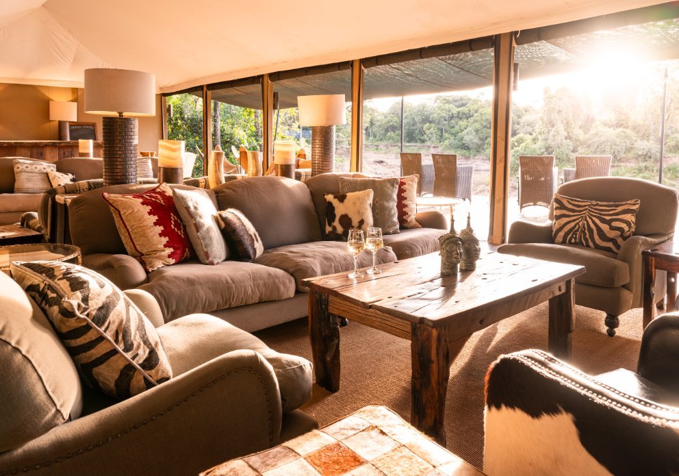 Governors' Il Moran Camp shared lounge with sofas and wooden coffee table