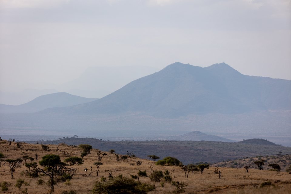 Wide landscape of grassland and distant hills; map guide