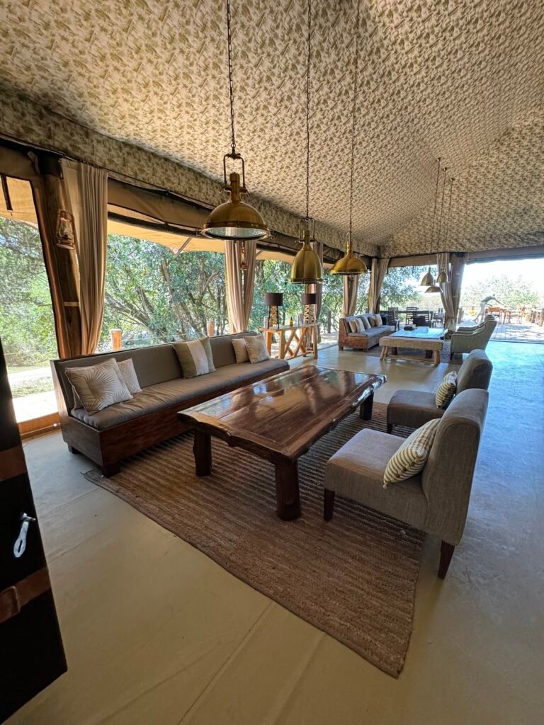 Ilkeliani Camp long shaded lounge with sofas and timber furniture