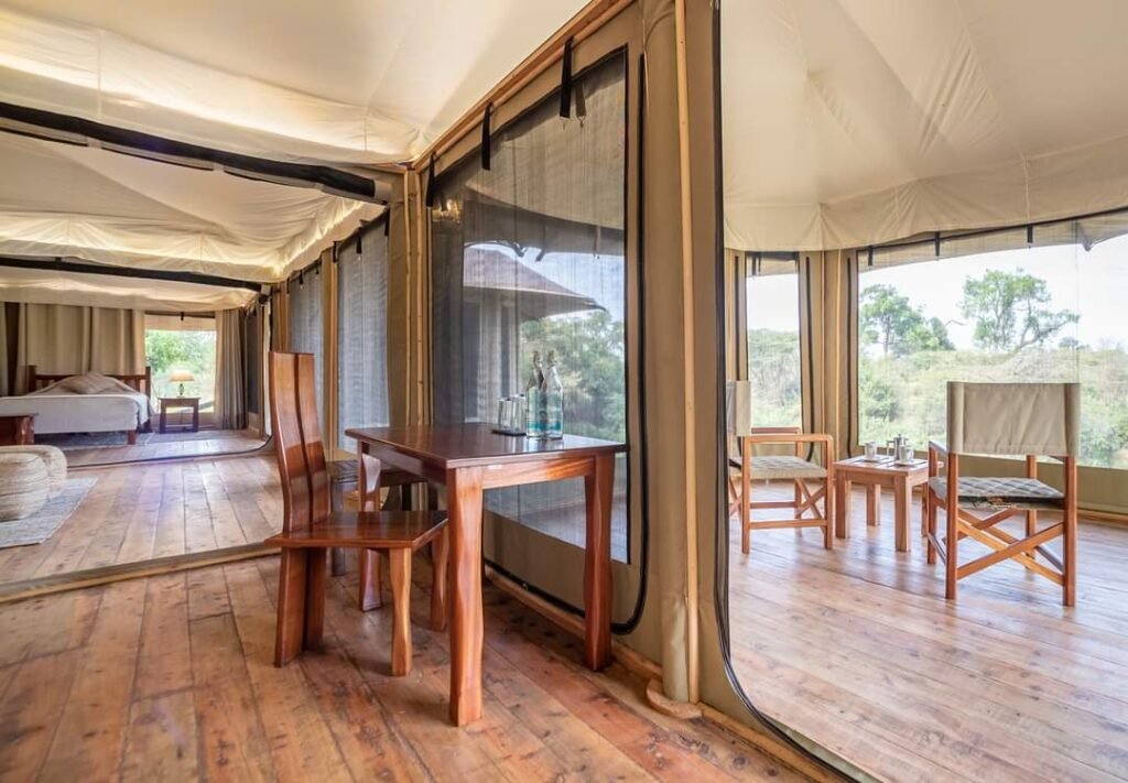 Canvas suite and timber veranda with outdoor chairs at Ilkeliani Camp
