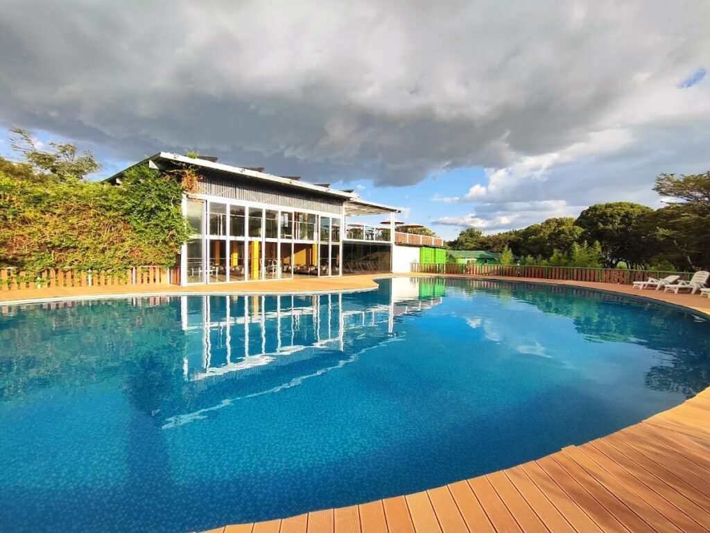 Jambo Mara Safari Lodge shared pool beside its glass-fronted communal building