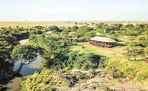 Mara Journal 4 Aerial view of a safari camp and trees beside a winding river