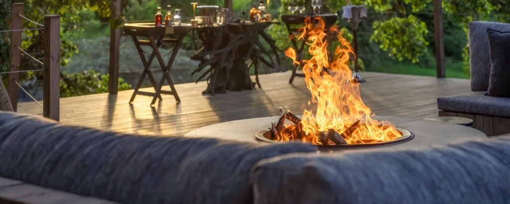 Maasai Mara lodges and camps 20 JW Marriott Maasai Mara Lodge firepit seating on a timber deck among trees