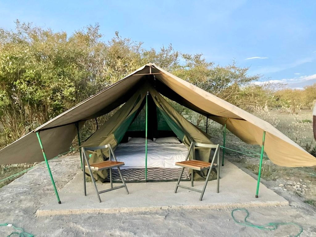 Kambu Mara Camp Classic Tent exterior with outdoor chairs