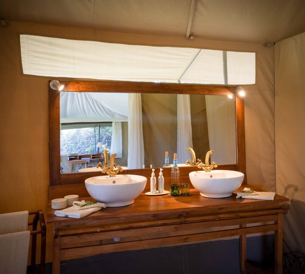 Double wash basins and timber vanity in a Kicheche Mara North tent bathroom