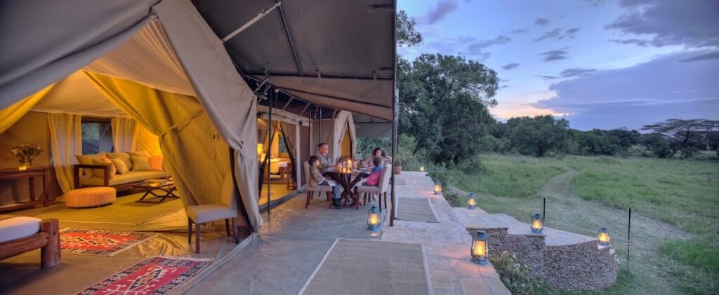 Maasai Mara lodges and camps 23 Kicheche Mara North canvas lounge opening onto the stream-side lawn at dusk
