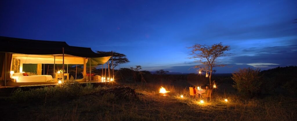 Maasai Mara lodges and camps 44 Kicheche Valley Naboisho elevated tent and private dining setting at dusk