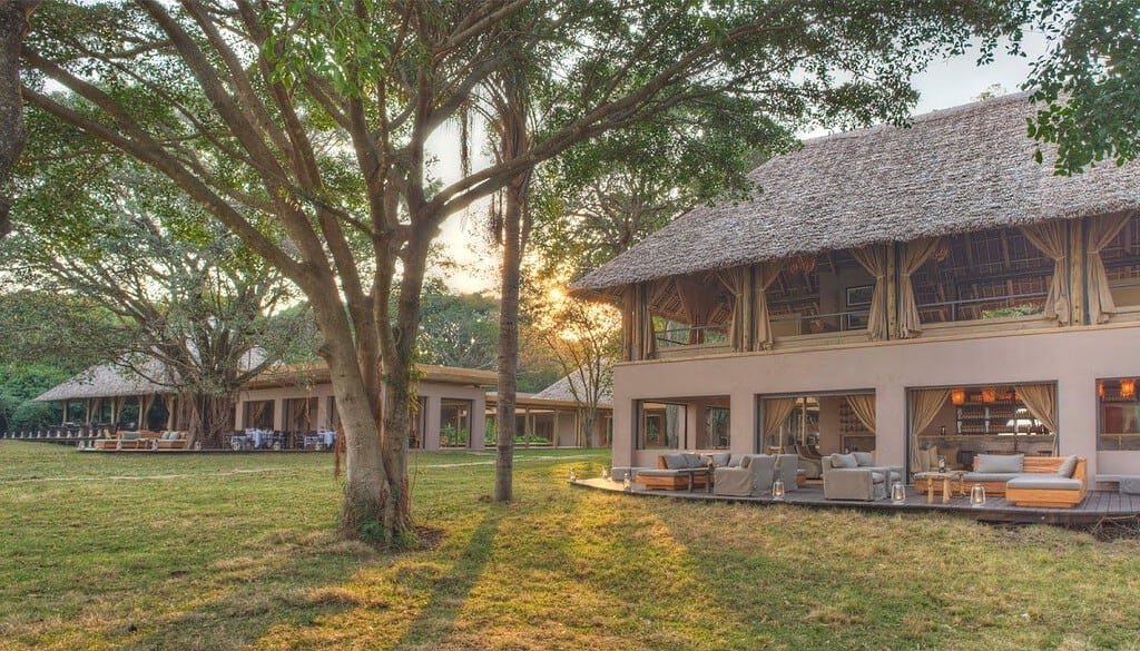 Split-level guest area at andBeyond Kichwa Tembo beside a shaded lawn
