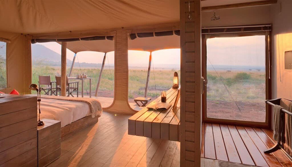 Canvas tent interior and private veranda overlooking the landscape at andBeyond Kichwa Tembo