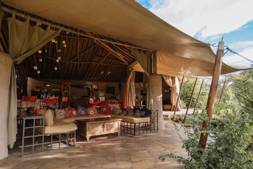 Kilima Camp open canvas lounge with colourful cushions and seating