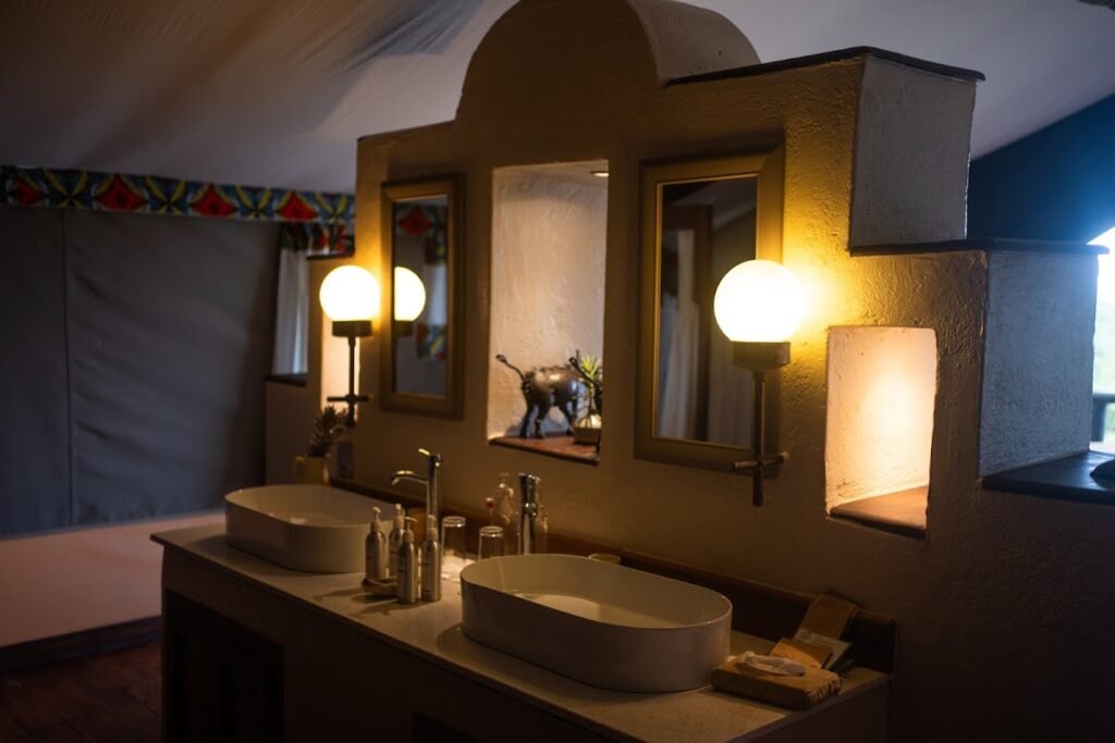 Double wash basins and mirrors in a Kilima Camp ensuite tent bathroom