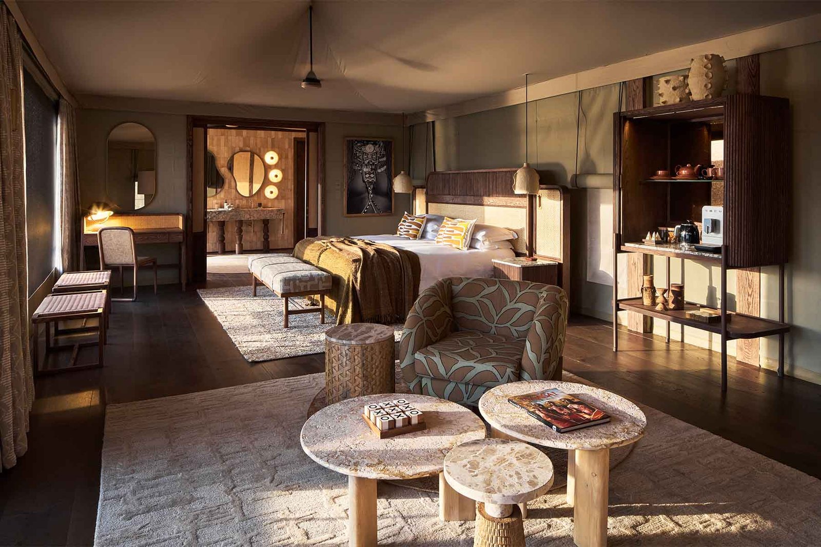 Kinara Safari Camp king tented suite with lounge seating and private bathroom