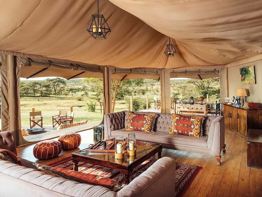 Canvas lounge at Saruni Leopard Hill with sofas, wooden table and leather pouffes