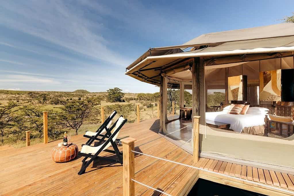 Maasai Mara lodges and camps 53 Saruni Leopard Hill round tent and wooden deck overlooking Naboisho Conservancy