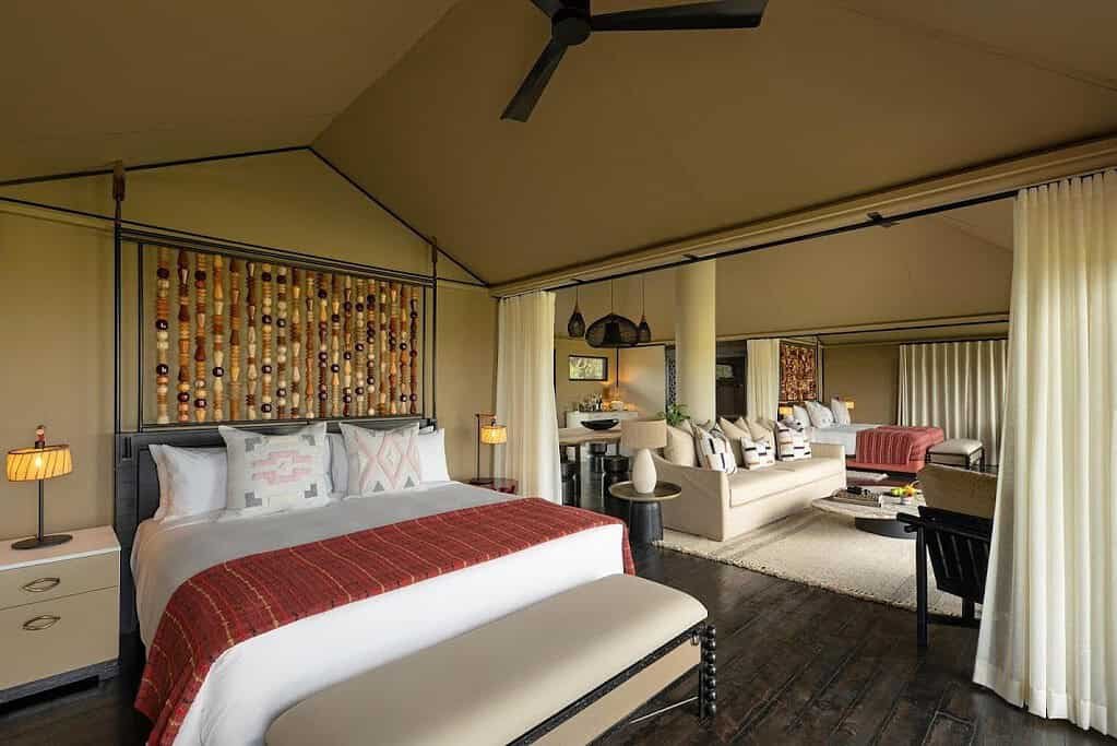 Tented suite bedroom with a double bed, canopy and a separate seating area