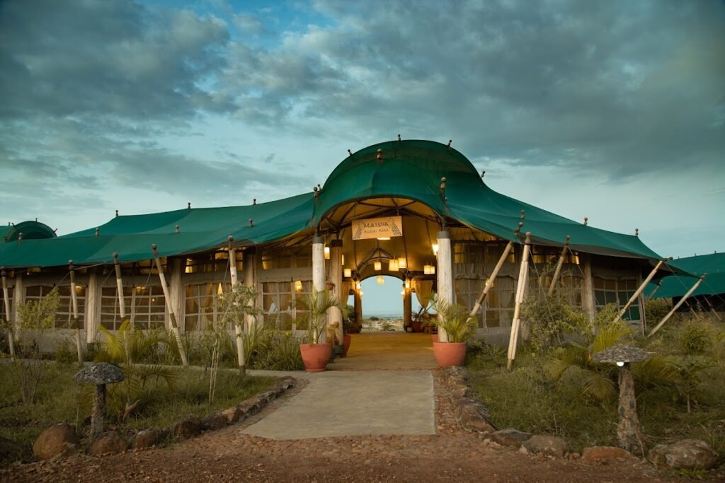 Maasai Mara lodges and camps 31 Mara Maisha Camp main canvas building with its curved green roof at dusk