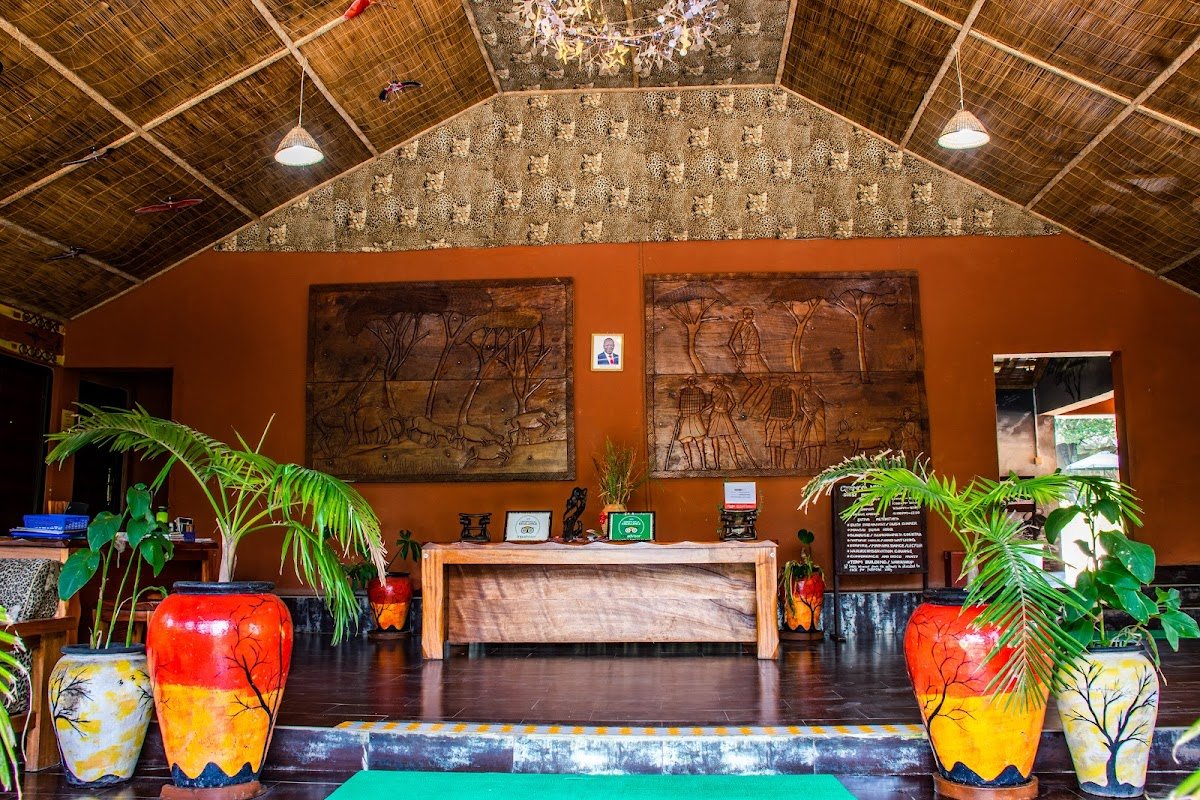 Mara Chui Resort reception hall with carved wall panels and a reed ceiling