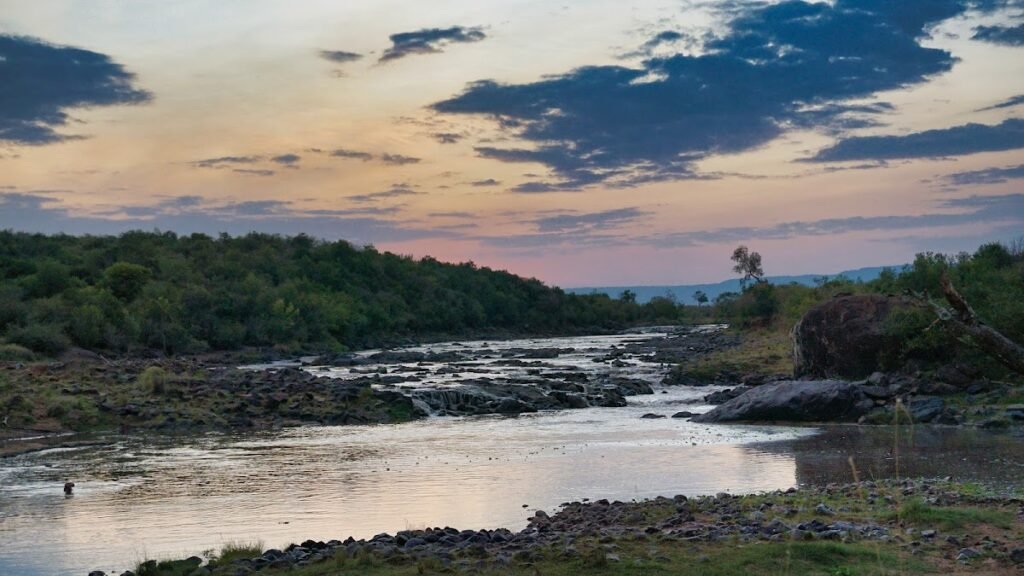 Wider Maasai Mara river rapids at sunset, illustrative landscape context