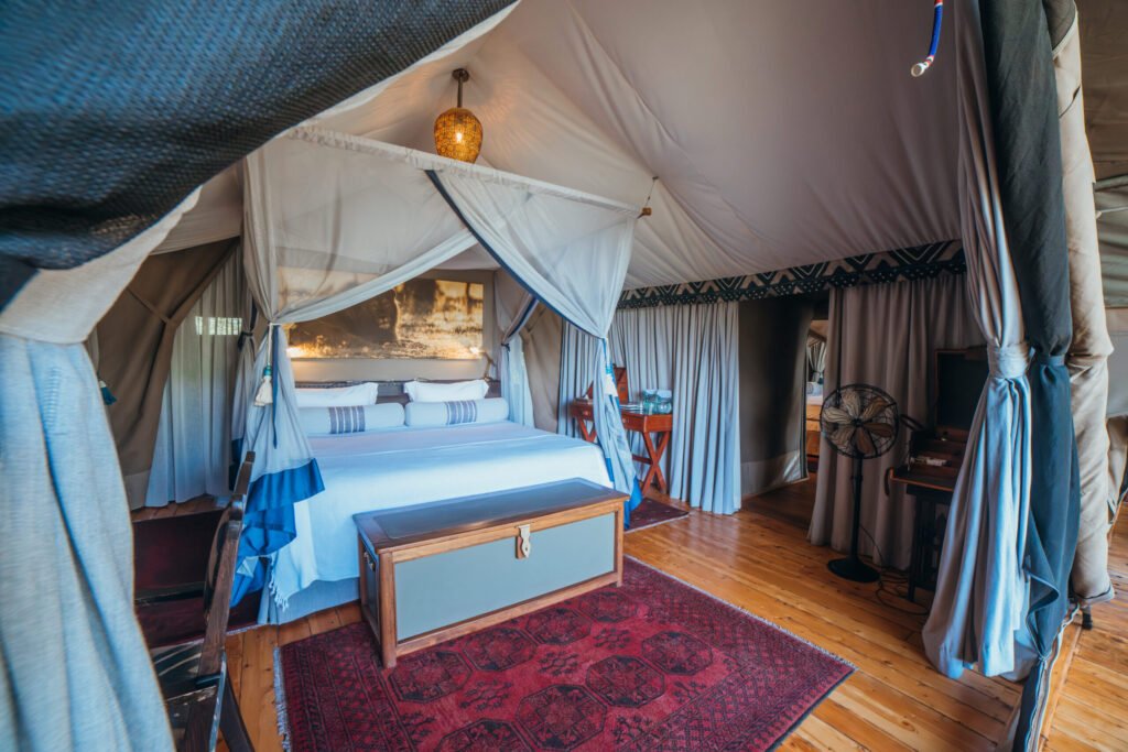 Mara Expedition Camp en-suite guest tent bedroom with double bed and mosquito net