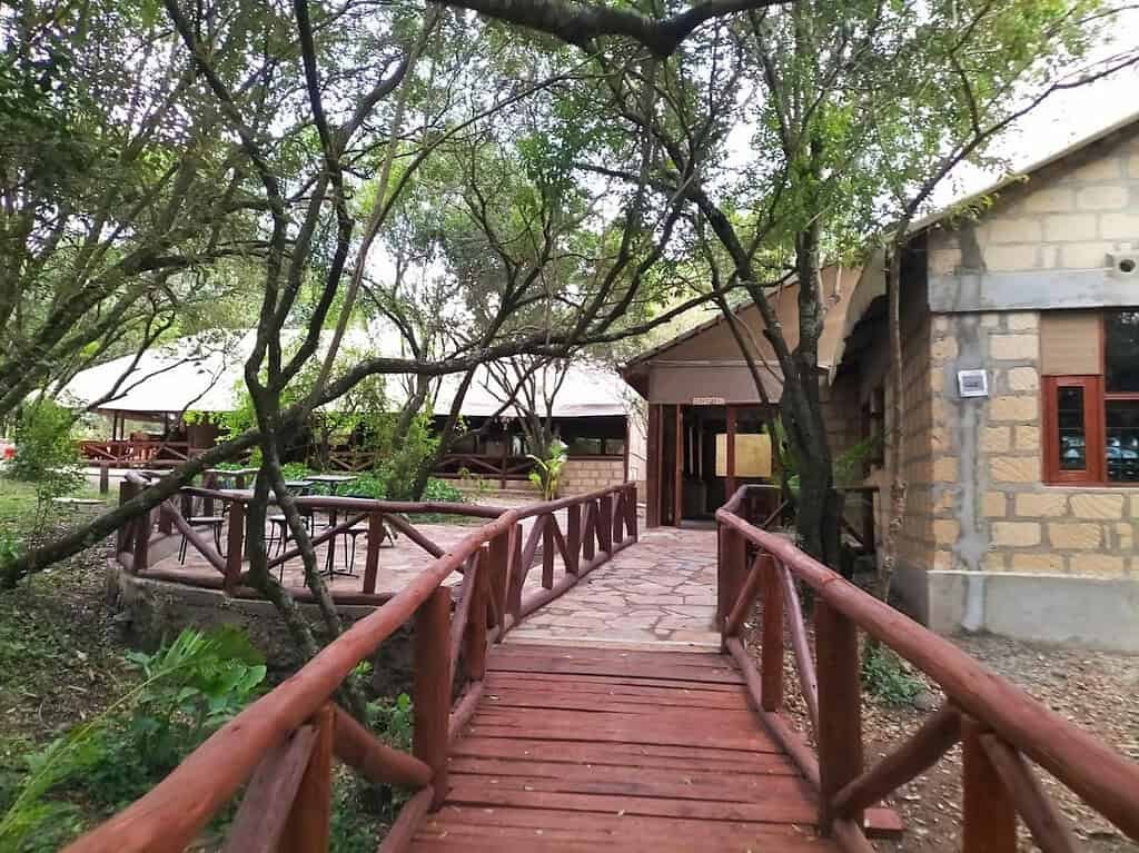 Self-catering accommodation in the Maasai Mara 2 Shaded wooden walkway connecting tented accommodation and outdoor seating