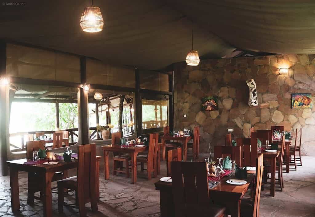 Self-catering accommodation in the Maasai Mara 4 Covered dining area with tables, chairs and views towards camp grounds