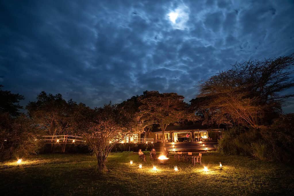 Maasai Mara lodges and camps 33 Mara Plains Camp communal tents and lantern-lit lawn in the evening