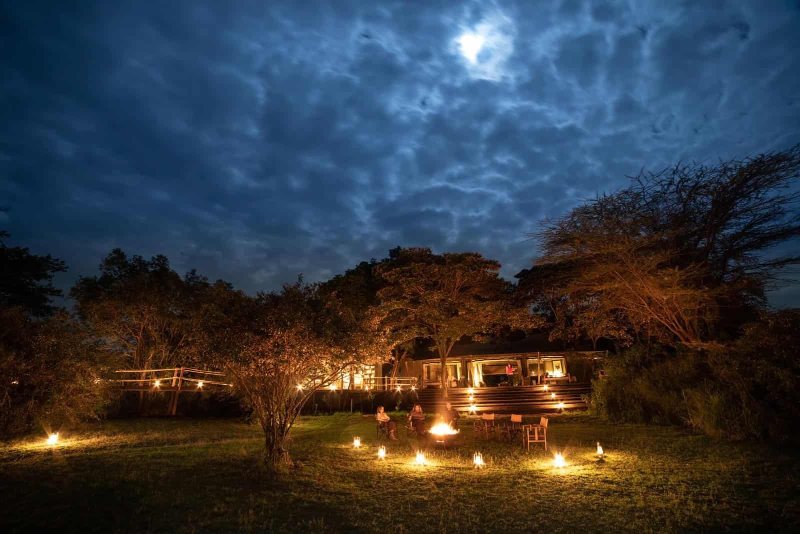 Mara Plains Camp communal tents and lantern-lit lawn in the evening