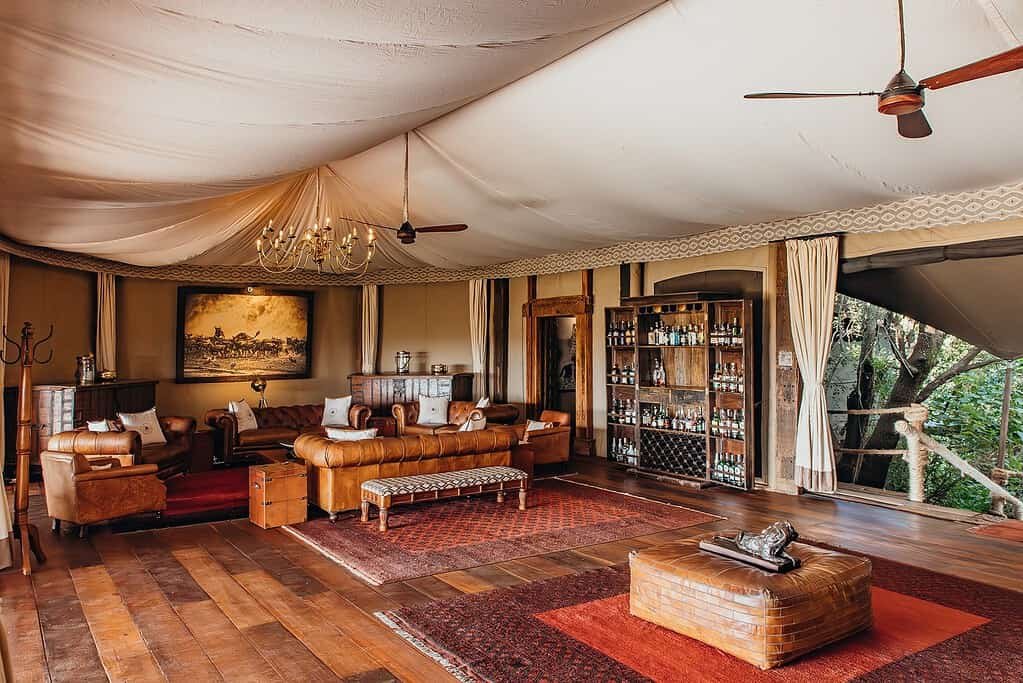 Mara Plains Camp main lounge with leather sofas and canvas ceiling