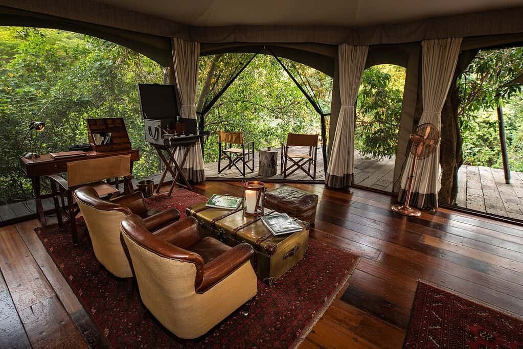Leather seating and a private veranda in a Mara Plains Camp Safari Suite